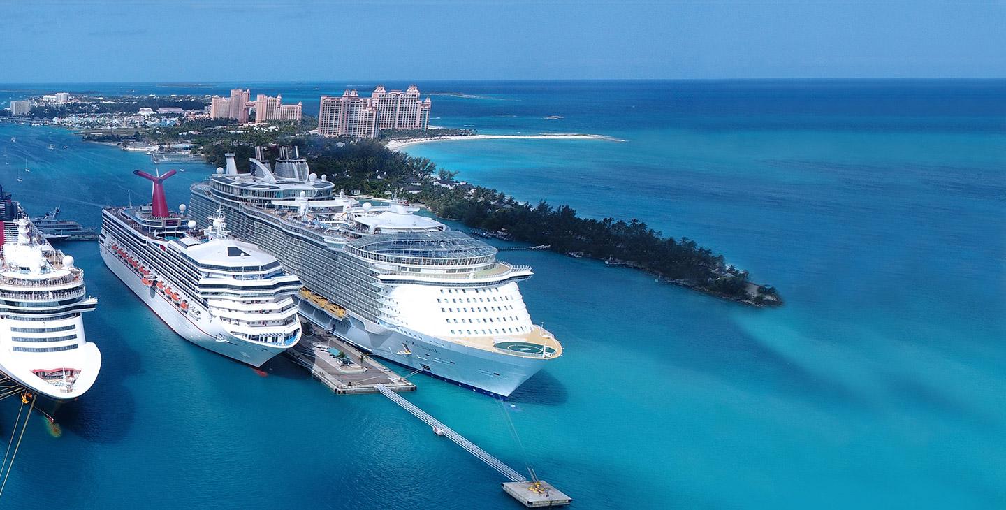 Passenger cruise ships equipped with boat internet docked near an island